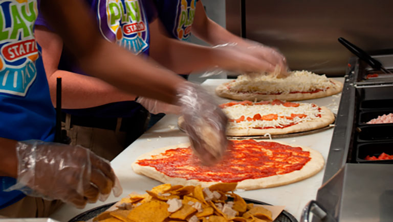 Employees Making Pizza
